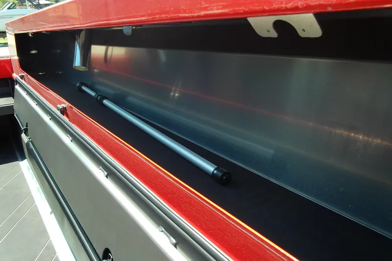 Slide: The Image of Storage compartment of 2026 Stabicraft 2050 Frontier boat, featuring sleek red interior design. - 17