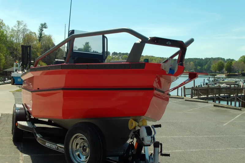 Slide: The Image of Red 2026 Stabicraft 2050 Frontier boat on trailer by a lakeside dock. - 3