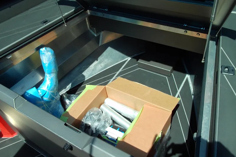 Slide: The Image of Storage compartment of 2026 Stabicraft 2050 Frontier with various items inside. - 8