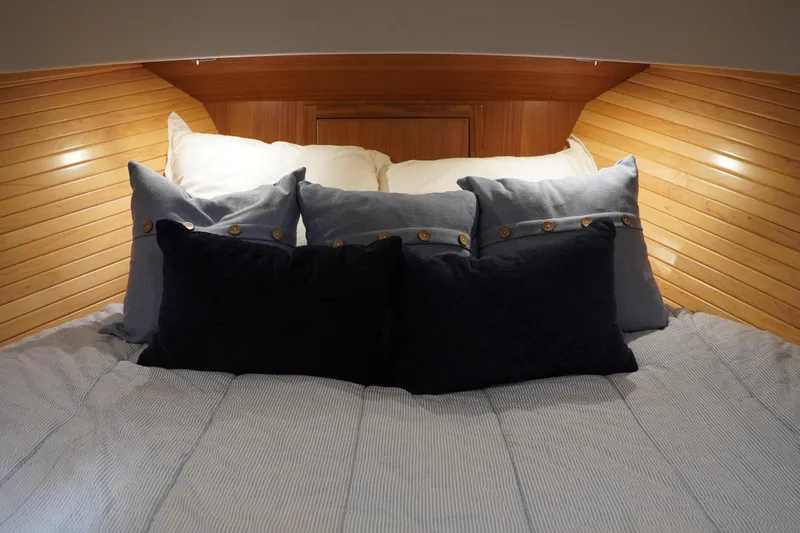 Slide: The Image of Cozy cabin bed with pillows in 2024 True North 34 boat interior. - 13
