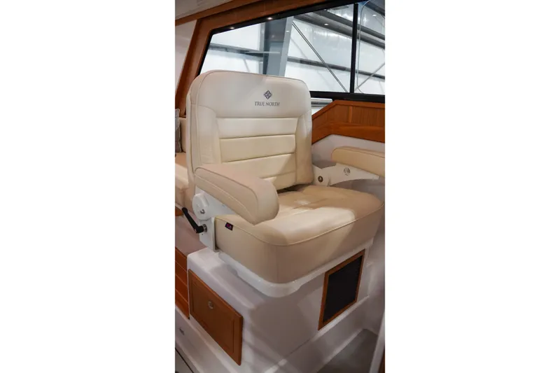 Slide: The Image of Luxurious captain's chair in 2024 True North 34 boat, featuring elegant beige upholstery. - 14