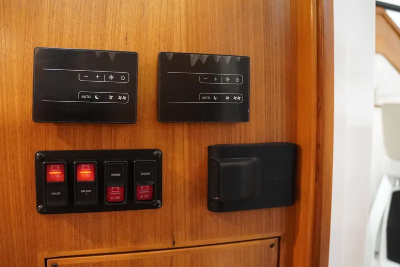 Slide: The Image of Control panel on 2024 True North 34 boat, featuring switches and digital displays. - 15