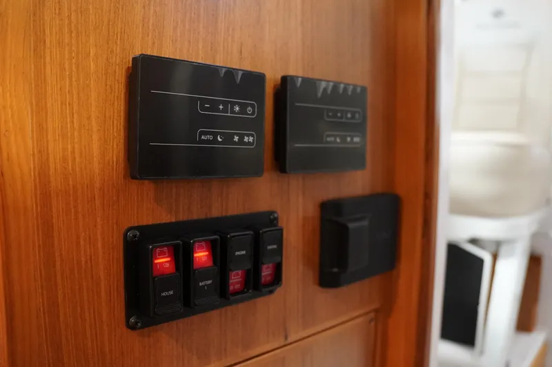 Slide: The Image of Control panel on 2024 True North 34 boat, featuring switches and digital displays. - 17