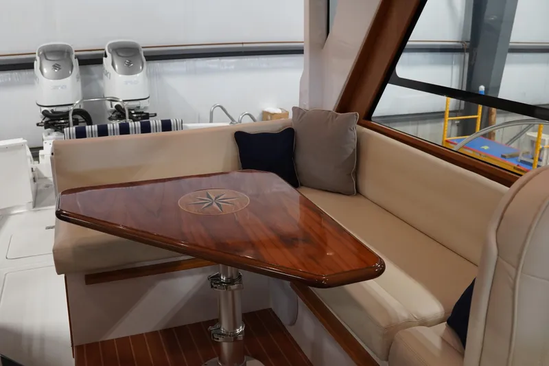 Slide: The Image of Luxurious interior of 2024 True North 34 boat with elegant wooden table and cushioned seating. - 18