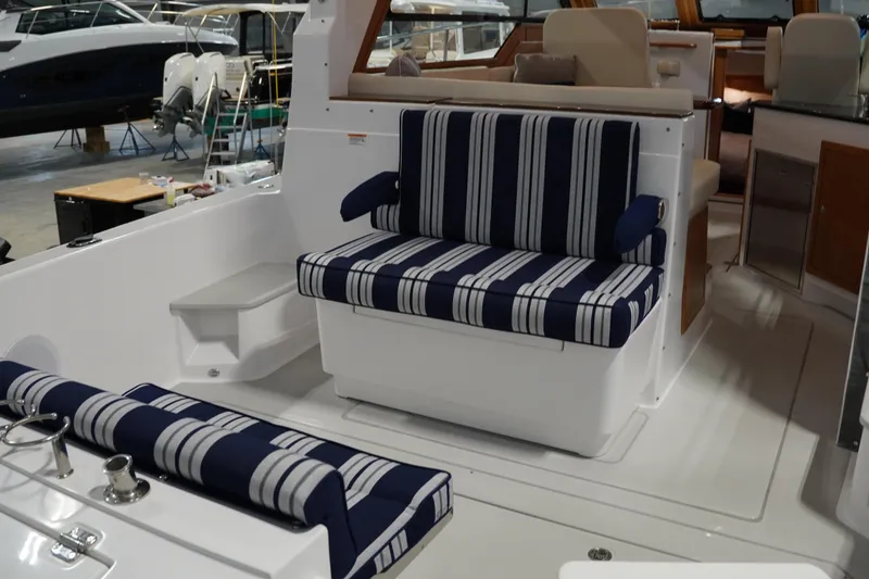 Slide: The Image of 2024 True North 34 boat interior with striped seating and modern design. - 27