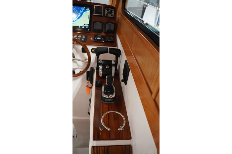 Slide: The Image of Helm of 2024 True North 34 boat with navigation controls and wooden accents. - 28