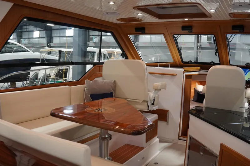 Slide: The Image of Luxurious interior of 2024 True North 34 yacht with elegant wood finishes and seating. - 30