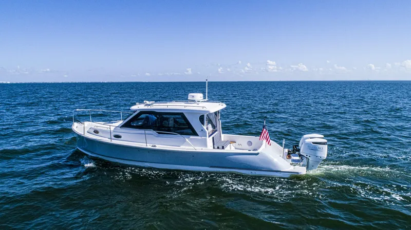 Slide: The Image of 2024 True North 34 Outboard Express boat cruising on open water. - 38