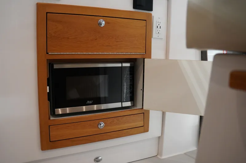 Slide: The Image of Built-in microwave in 2024 True North 34 yacht kitchen cabinetry. - 6