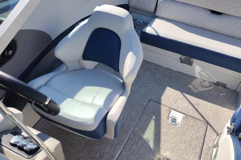 Slide: The Image of 2017 Crownline 225 SS boat interior with cushioned seating and steering wheel. - 11