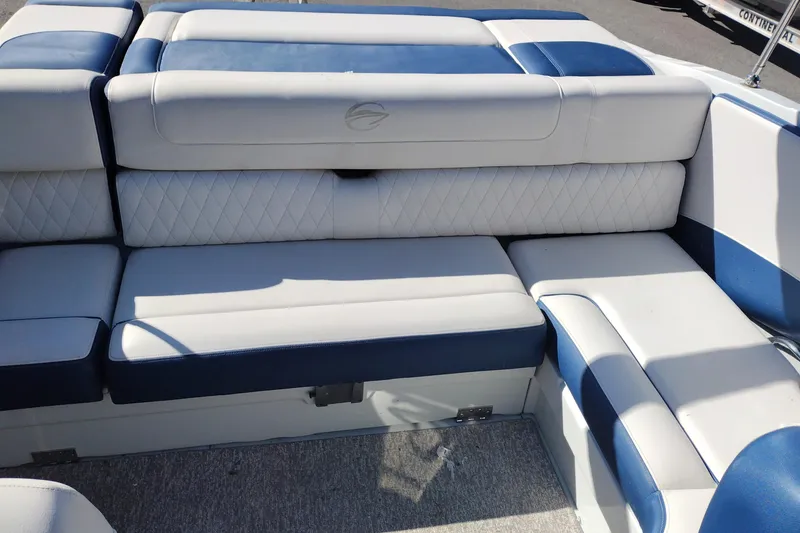 Slide: The Image of 2017 Crownline 225 SS boat interior with blue and white cushioned seating. - 14