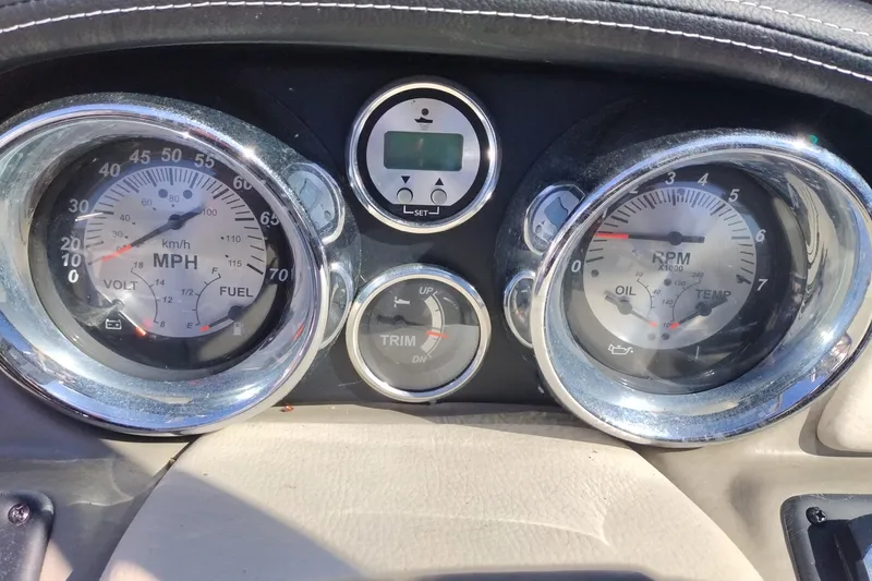 Slide: The Image of Dashboard of a 2017 Crownline 225 SS boat showing speedometer and RPM gauges. - 16