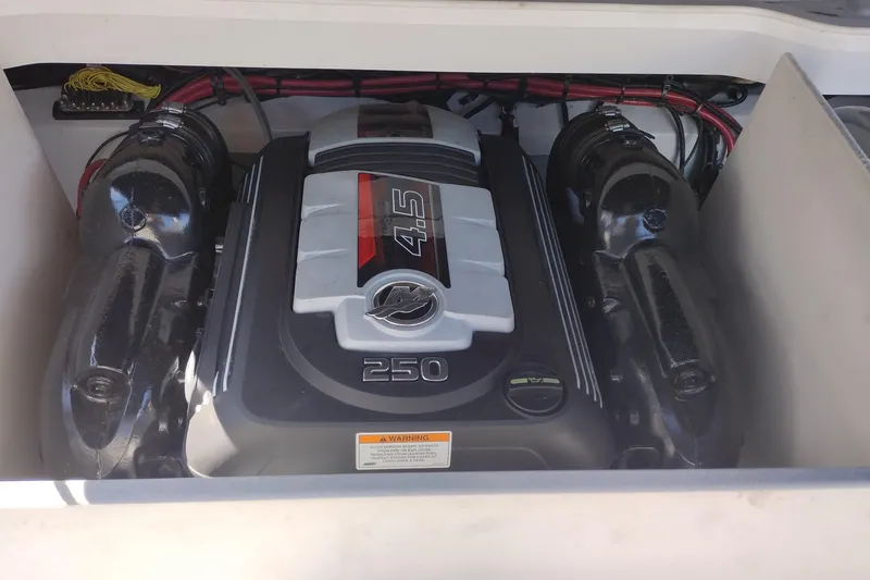 Slide: The Image of Engine compartment of a 2017 Crownline 225 SS boat, featuring a 4.5L 250 horsepower engine. - 17