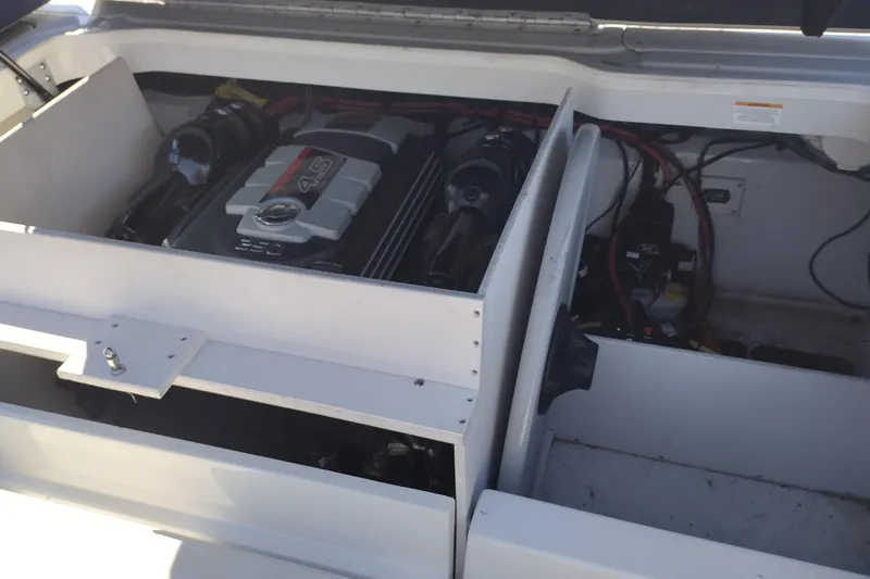 Slide: The Image of Engine compartment of a 2017 Crownline 225 SS boat, showcasing the motor and wiring. - 19