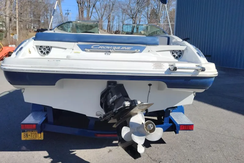 Slide: The Image of 2017 Crownline 225 SS boat on trailer, rear view with visible propeller. - 2