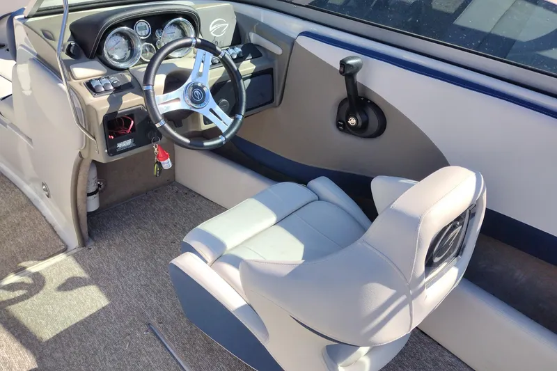 Slide: The Image of 2017 Crownline 225 SS boat interior with steering wheel and captain's seat. - 23