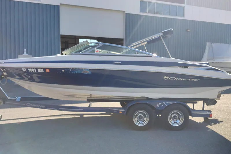 Slide: The Image of 2017 Crownline 225 SS boat on trailer, parked outdoors. - 4