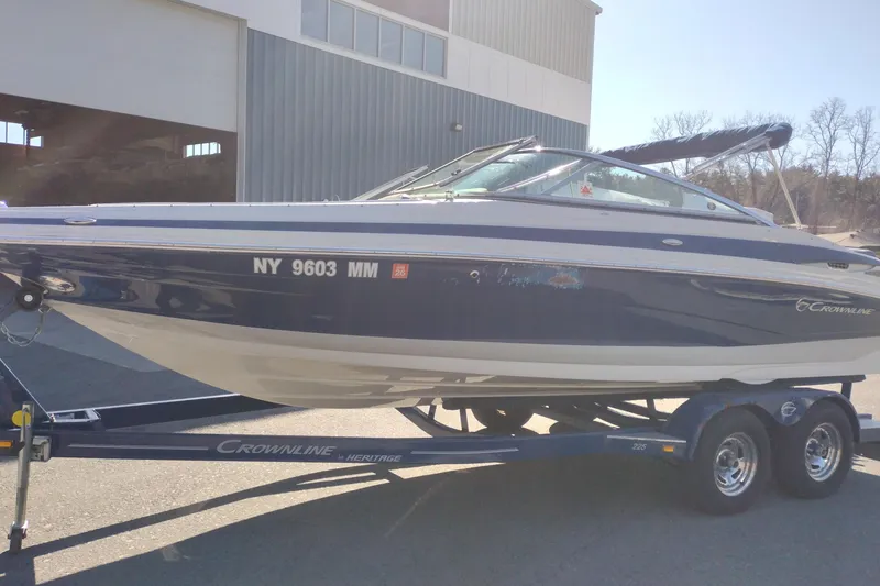 Slide: The Image of 2017 Crownline 225 SS boat on trailer outside a building. - 5