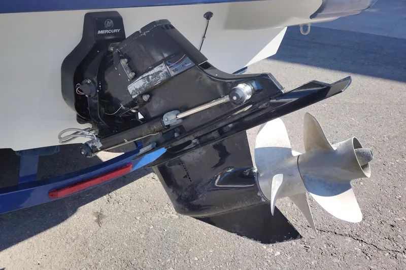 Slide: The Image of Close-up of a 2017 Crownline 225 SS boat's Mercury outboard motor and propeller. - 6