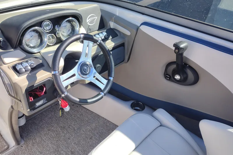 Slide: The Image of 2017 Crownline 225 SS boat dashboard with steering wheel and control panel. - 9