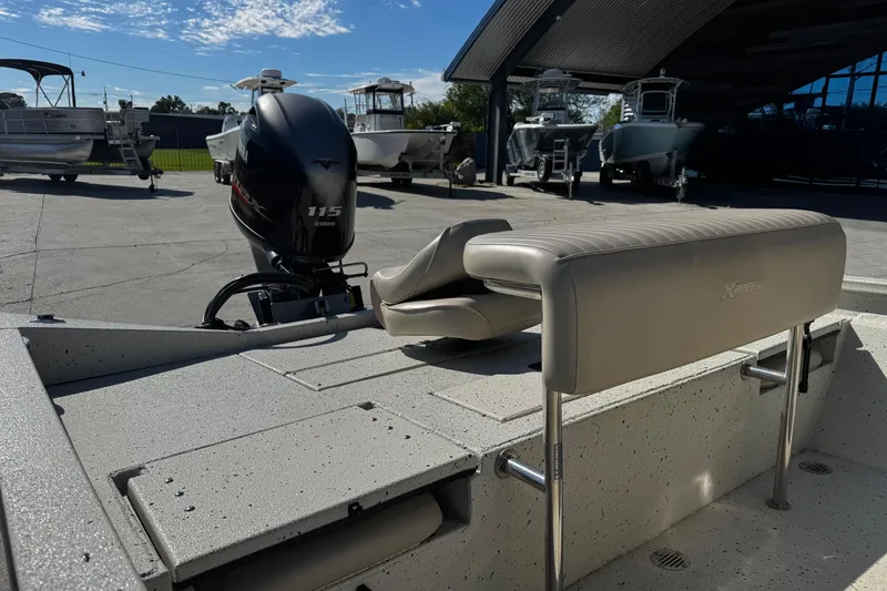 Slide: The Image of 2017 Xpress H20B Bay boat with Yamaha 115 engine, parked in a marina. - 10