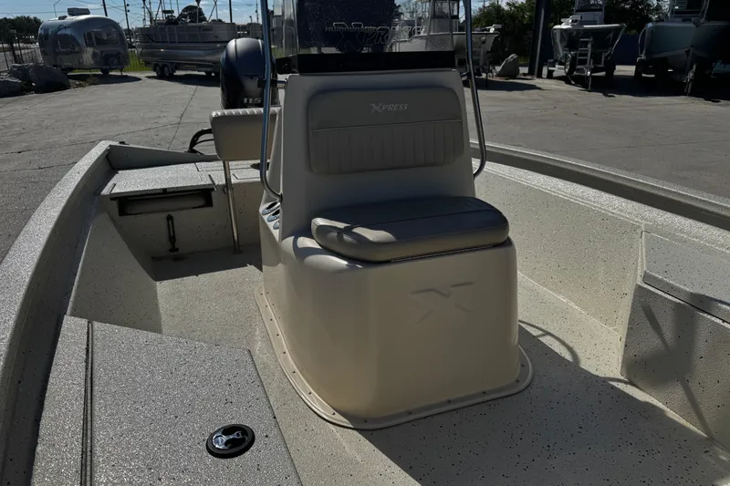 Slide: The Image of 2017 Xpress H20B Bay boat interior with seating and console, parked outdoors. - 11