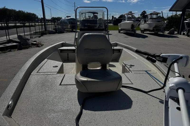 Slide: The Image of 2017 Xpress H20B Bay boat with seating and steering console, parked outdoors. - 12