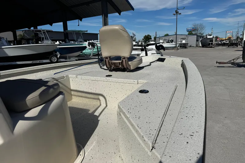 Slide: The Image of 2017 Xpress H20B Bay boat interior with seating, parked outdoors under a clear sky. - 13