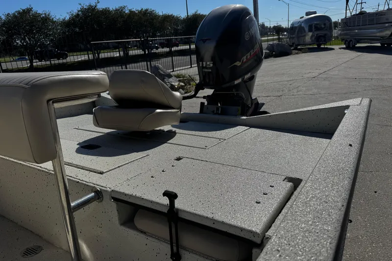 Slide: The Image of 2017 Xpress H20B Bay boat with Yamaha 115 engine, parked outdoors. - 14