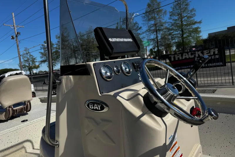 Slide: The Image of 2017 Xpress H20B Bay boat dashboard with steering wheel and Humminbird device. - 16