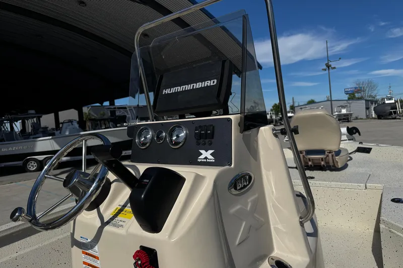 Slide: The Image of 2017 Xpress H20B Bay boat dashboard with steering wheel and Humminbird display. - 18