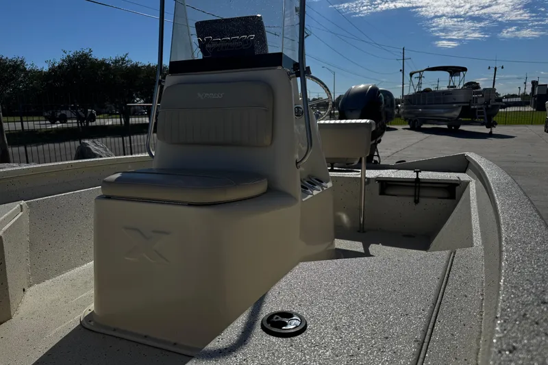 Slide: The Image of 2017 Xpress H20B Bay boat interior with seating and console, parked outdoors. - 19