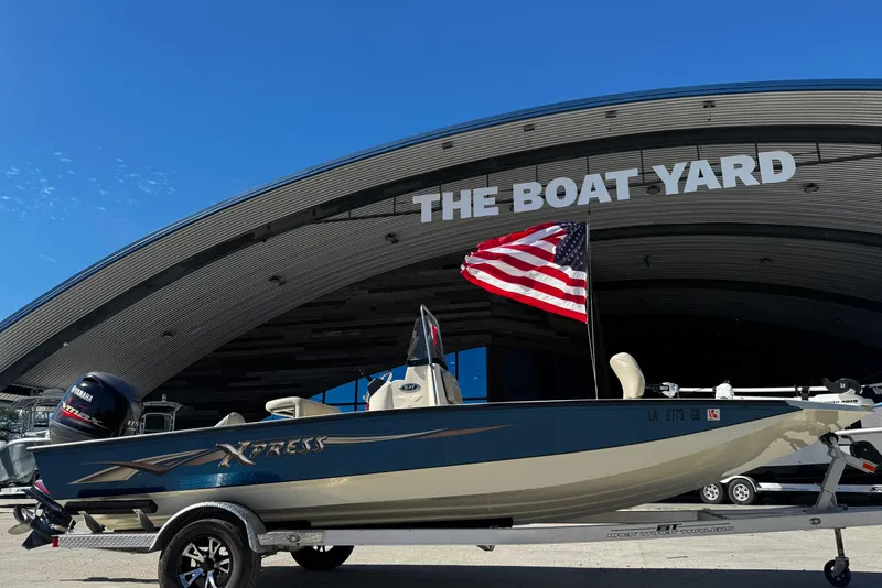Slide: The Image of 2017 Xpress H20B Bay boat with American flag at The Boat Yard. - 4