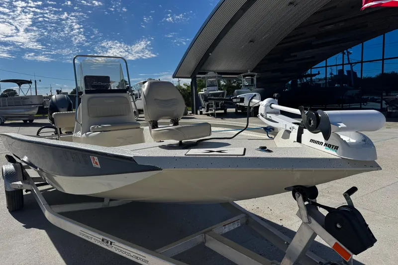 Slide: The Image of 2017 Xpress H20B Bay boat on trailer, featuring Minn Kota trolling motor. - 9