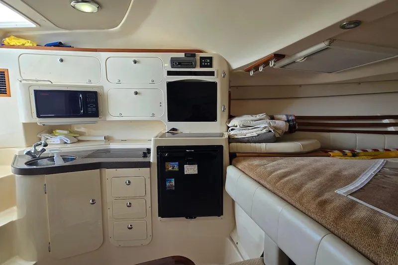 Slide: The Image of Interior of 2006 Grady-White Express 330 boat with kitchenette and sleeping area. - 16