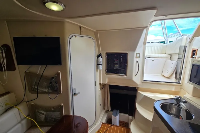 Slide: The Image of Interior of 2006 Grady-White Express 330 boat with TV, control panel, and stairs to deck. - 17