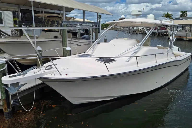 Slide: The Image of 2006 Grady-White Express 330 boat docked in a marina under a cloudy sky. - 3