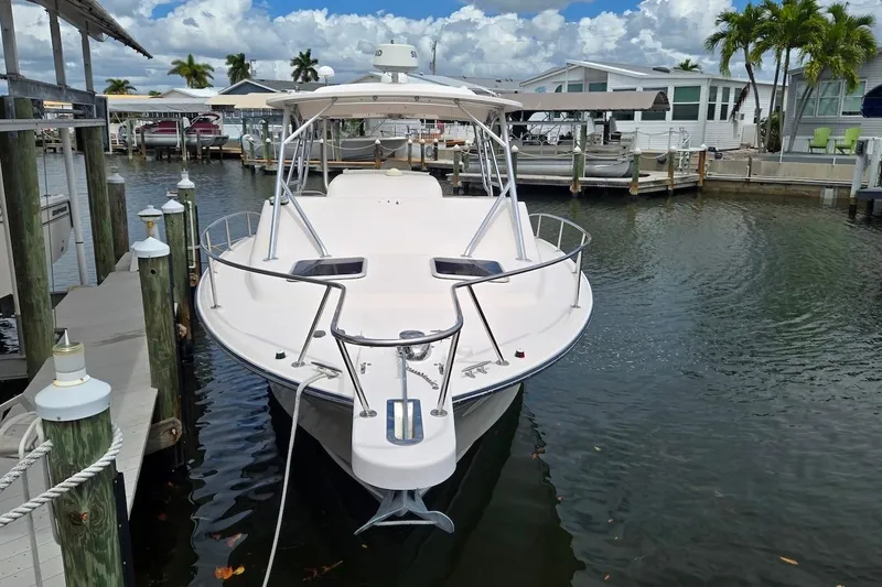 Slide: The Image of 2006 Grady-White Express 330 boat docked in a marina under a partly cloudy sky. - 4