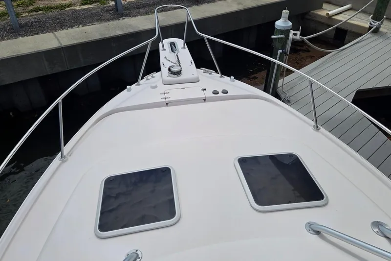 Slide: The Image of Bow view of 2006 Grady-White Express 330 boat docked at marina. - 5