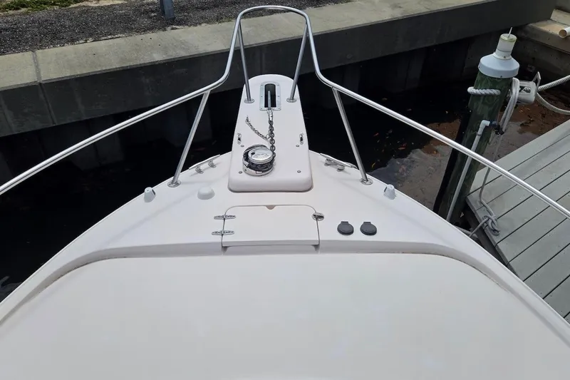 Slide: The Image of 2006 Grady-White Express 330 boat bow with anchor chain and railing at dock. - 6