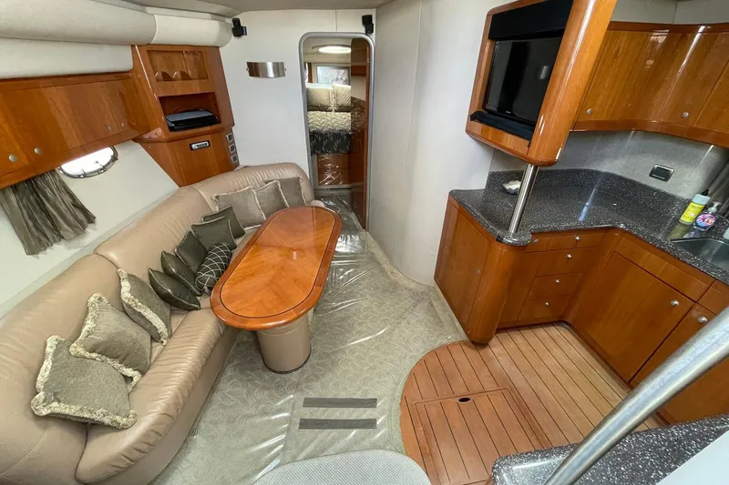 Slide: The Image of Interior of a 2005 Formula 48 Yacht with elegant wood finishes and cozy seating area. - 10