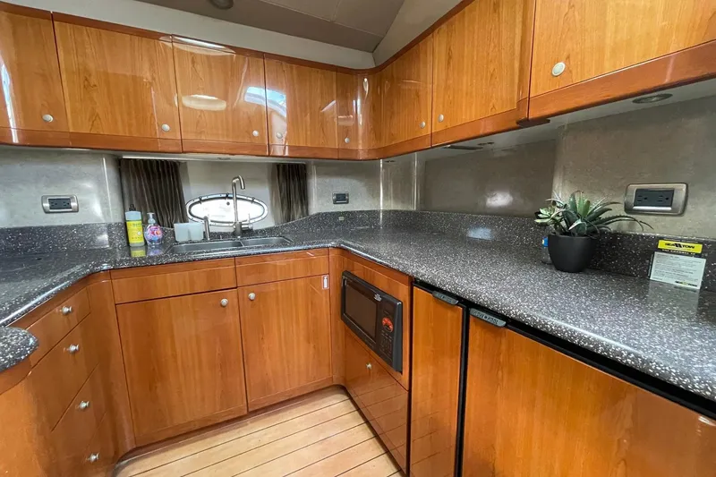 Slide: The Image of Luxurious kitchen interior of a 2005 Formula 48 Yacht with wooden cabinets and modern appliances. - 14