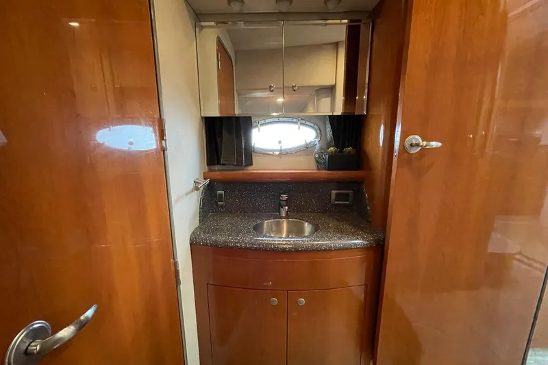 Slide: The Image of 2005 Formula 48 Yacht bathroom with wooden cabinetry and stainless steel sink. - 15