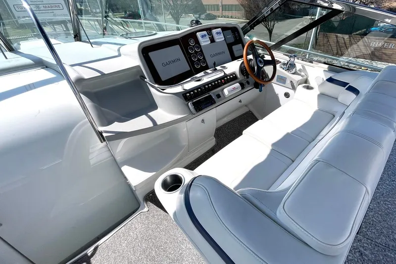 Slide: The Image of 2005 Formula 48 Yacht cockpit with Garmin navigation, luxurious seating, and modern controls. - 2