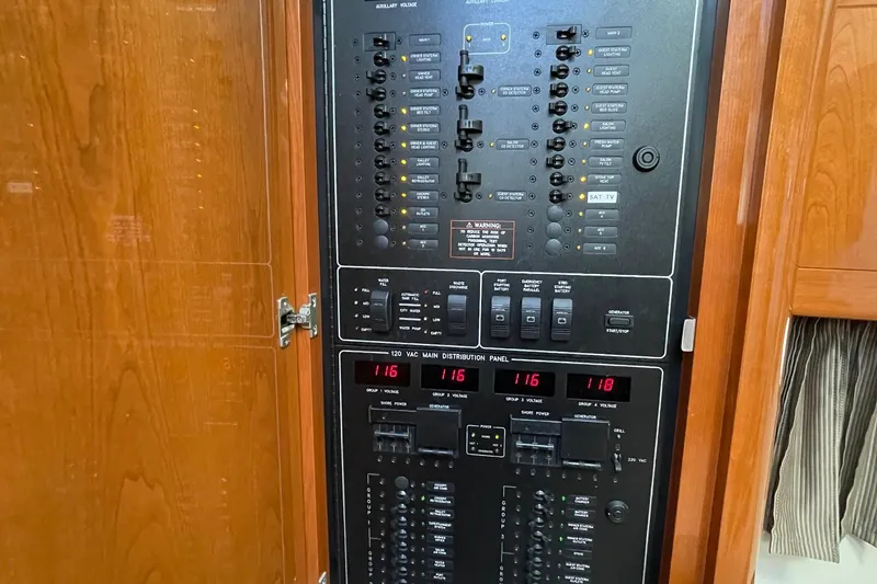 Slide: The Image of Electrical control panel inside a 2005 Formula 48 Yacht, featuring various switches and voltage displays. - 20