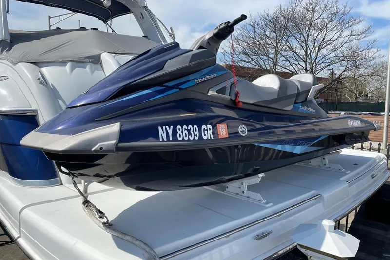 Slide: The Image of 2005 Formula 48 Yacht with Yamaha jet ski on deck, docked outdoors. - 21