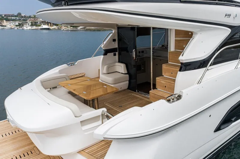 Slide: The Image of 2024 Princess F45 yacht with elegant outdoor seating and wooden deck. - 10