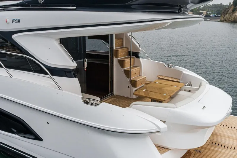 Slide: The Image of 2024 Princess F45 yacht with elegant outdoor seating and wooden stairs. - 11