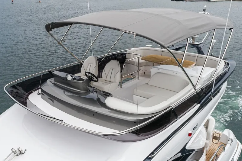 Slide: The Image of 2024 Princess F45 yacht with spacious deck and canopy on the water. - 14