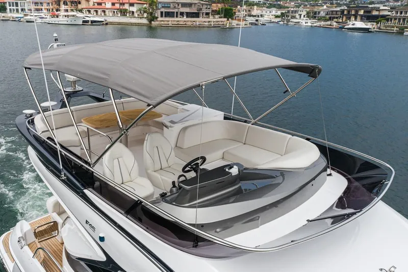Slide: The Image of 2024 Princess F45 yacht with spacious deck and canopy on a serene waterfront. - 15